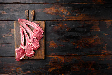 Fresh lamb rib chop, on old dark  wooden table background, top view flat lay, with copy space for...