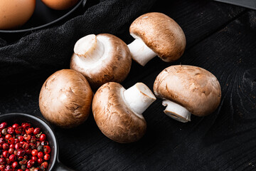 Royal mushrooms champignon whole, on black wooden table background