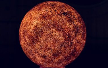 Red planet model close up on black background. Space concept