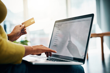Treat yourself to the convenience of online shopping. Cropped shot of a woman using her credit card to make an online payment at home.