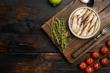 Smoked fish with olive oil, on old dark  wooden table background, top view flat lay, with copy space for text