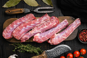 Bird chicken giblets gizzards stomachs, on black wooden table background, top view flat lay