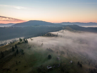 Sunrise over the fog in the Ukrainian Carpathians. Aerial drone view.