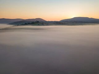 Fototapeta premium Morning fog in the Ukrainian Carpathians. Aerial drone view.