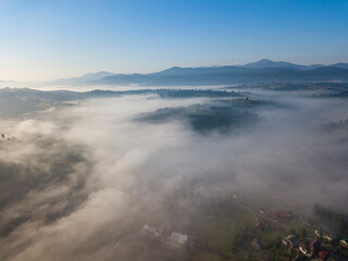 Green mountains of the Ukrainian Carpathians in the morning mist. Aerial drone view.