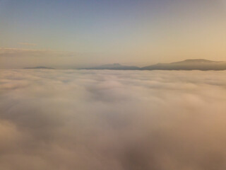 Obraz na płótnie Canvas Sunrise over the fog in the Ukrainian Carpathians. Aerial drone view.