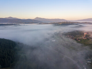 Sunrise over the fog in the Ukrainian Carpathians. Aerial drone view.
