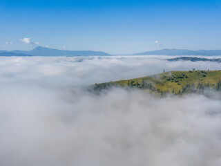 Morning fog in the Ukrainian Carpathians. Aerial drone view.