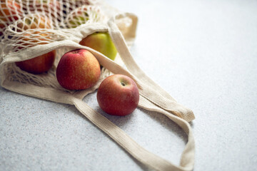 Eco friendly hand bag with ripe apples on the table