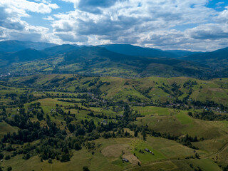 Obraz premium Green mountains of Ukrainian Carpathians in summer. Coniferous trees on the slopes. Aerial drone view.
