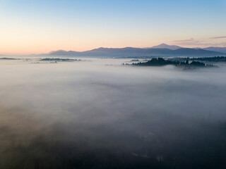 Sunrise over the fog in the Ukrainian Carpathians. Aerial drone view.