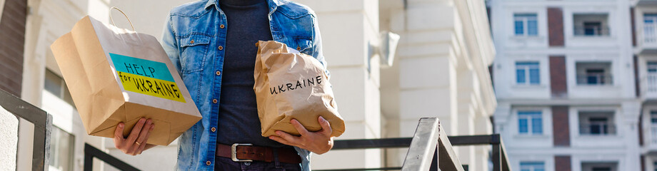 a man holds a box with humanitarian aid to ukraine