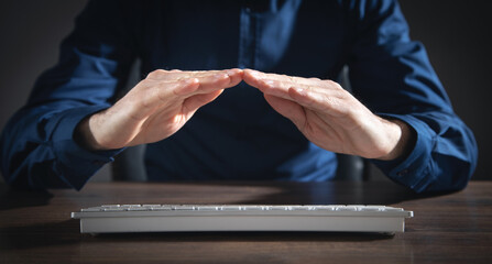 Man shows a protective gesture with his hands.