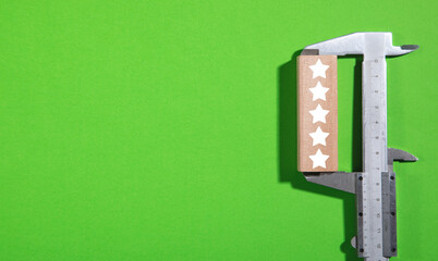 Vernier caliper with a 5 stars on wooden block.