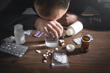 Caucasian depressed man with a pills.