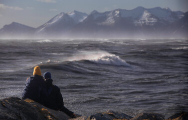 a young couple look at the mountains