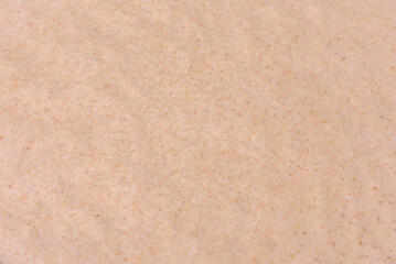 Rolled out prepared raw dough on parchment and baking sheet