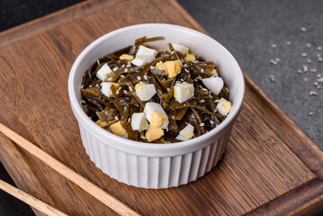Far Eastern salad - sea kale with egg in a white cup top