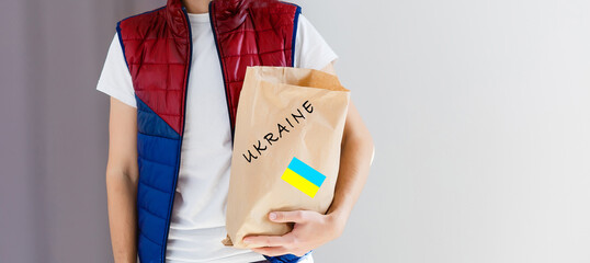 a man holds a box with humanitarian aid to ukraine