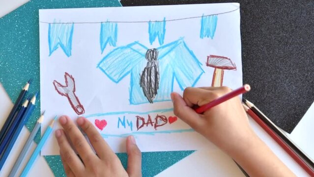 A child draws a postcard for father's day. A beautiful postcard with a shirt and tools for father's Day