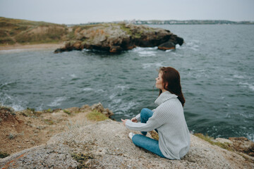 Fototapeta na wymiar woman beach tourism cloudy weather stone coast Lifestyle