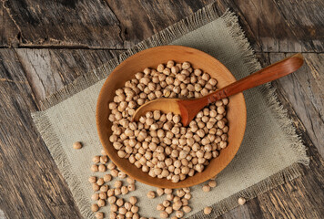 Chickpeas in a bowl on a rough cloth or burlap on an old rustic table
