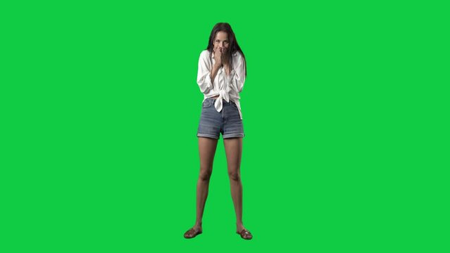 Excited cheerful shocked woman reaction looking at camera. Full body isolated on green screen background