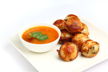 Kuzhi Paniyaram served with coconut chutney and sambar- South Indian breakfast