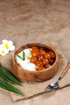 Bubur Sumsum or Bubur Lemu is traditional porridge from West Java, made from rice flour and candil (sticky rice ball), served with palm sugar syrup.