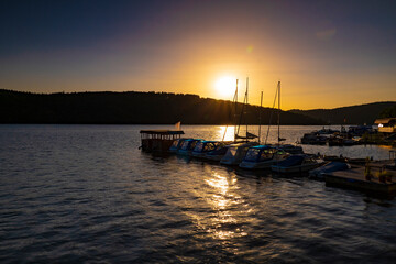 Fototapeta premium Beautiful sunset behind a marina on Lake Edersee, Hesse, Germany
