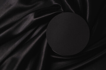 Empty round platform podium on beautiful black color background with drapery and wavy folds of silk...