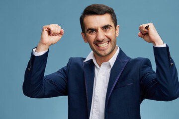 businessman bares his teeth with a pen in his hand posing self-confidence isolated background