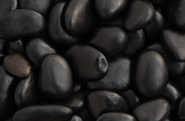 Texture and pattern black stones background.top view.
