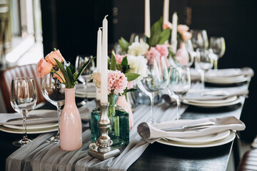 Wedding. Banquet. Decor. Festive tables are decorated with fabric, compositions of flowers and...