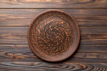 Top view of empty plate on wooden background. Empty space for your design