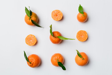 Many fresh ripe mandarin as colored background, top view. Elegant background of clementines and mandarin slices Top view flat lay