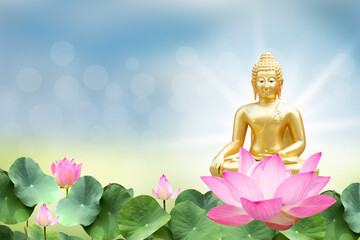 Vesak day concept: Buddha statue and lotus on bokeh background.