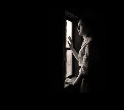 Woman praying at the window