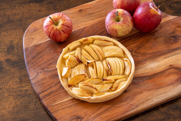 apple pie baked with fresh apples on a wooden background