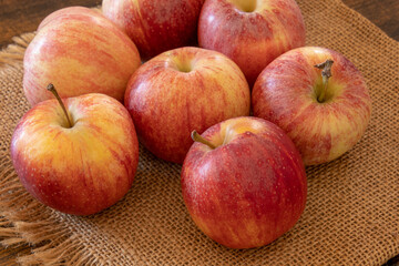 view of red apples isolated on a burlap