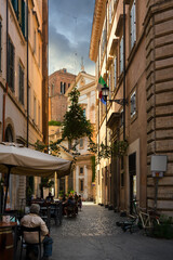 Obraz premium Street cafe on narrow old street in Rome