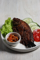Ikan Nila Bakar sambal bawang, indonesian traditional grilled nille tilapia fish with chilli garlic sauce.