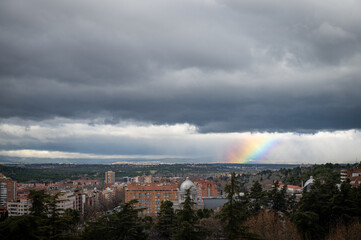 urban landscape of the cloudy sky with rainbow from the courtyard of the royal palace of madrid