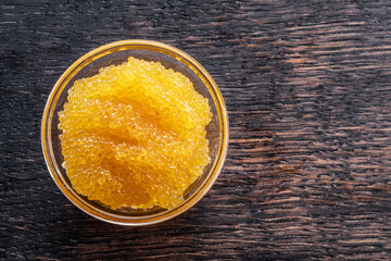 Pike caviar or roe in the bowl on wooden background.