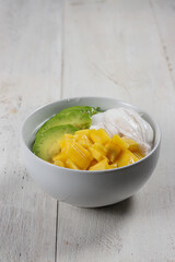 Es Teler, traditional Indonesian ice dessert made from tropical fruit cocktail in sweet coconut water and condensed milk.