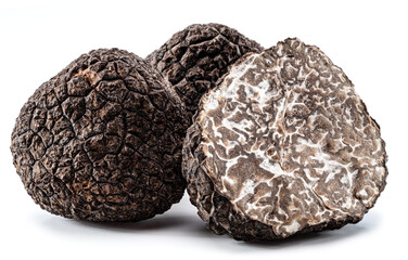 Black winter truffles and truffle cross section on white background. The most famous of the...