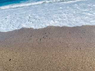 Sand on the beach with a sea wave