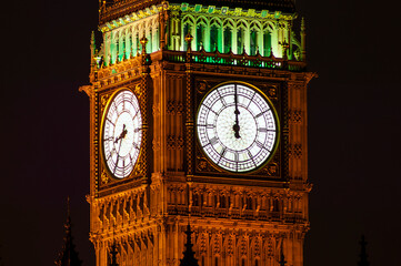 Big Ben of the Houses of Parliament London England UK at night striking midnight on new year's eve...