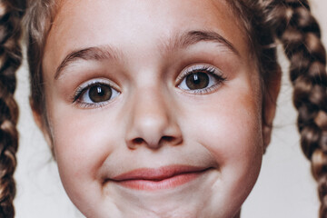 Funny face of cute young girl. Portrait of Pretty little girl with pigtails