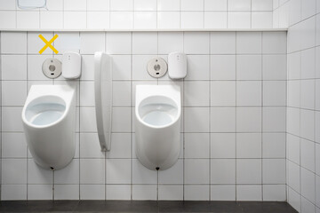 Alternature usage marking for social distance rules in the toilet urinate bowl. Epidemic protection measures. Social distancing concept